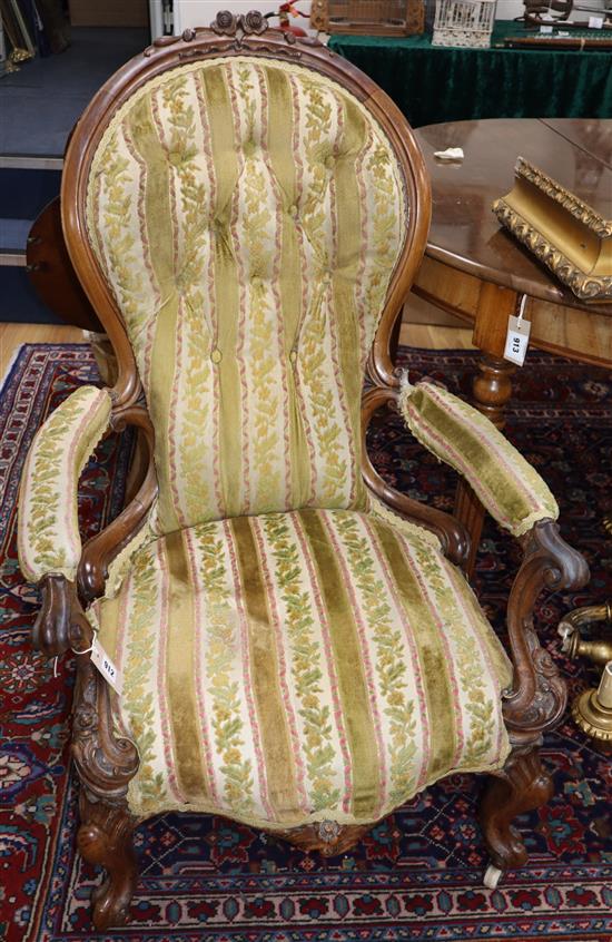 A Victorian carved walnut open armchair (a.f.) and a Victorian carved walnut nursing chair